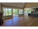 Open-concept living room with fireplace, hardwood floors, views of deck, kitchen with stainless appliances and island at 5480 Thom Rd, Mebane, NC 27302