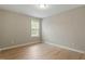 Bedroom with hardwood floors and a bright window providing natural light at 5604 Stardust Dr, Durham, NC 27712