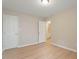 Bedroom with wood floors, neutral paint, and adjoining bathroom at 5604 Stardust Dr, Durham, NC 27712