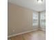 Bedroom with hardwood floors and two bright windows providing natural light at 5604 Stardust Dr, Durham, NC 27712