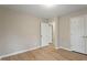 Bedroom with wood floors, neutral paint, and entry ways at 5604 Stardust Dr, Durham, NC 27712