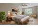 Bright bedroom with a ceiling fan, ample natural light, wood-look floors, and comfortable furniture at 5604 Stardust Dr, Durham, NC 27712