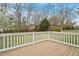 Large wooden deck overlooking an expansive yard with mature trees and flowering bushes at 5604 Stardust Dr, Durham, NC 27712