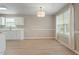 Bright dining area with modern chandelier, neutral walls, and natural light from large window at 5604 Stardust Dr, Durham, NC 27712