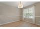 Bright dining room with a modern chandelier and a window at 5604 Stardust Dr, Durham, NC 27712
