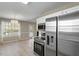 Updated kitchen area with stainless steel appliances and access to dining area at 5604 Stardust Dr, Durham, NC 27712