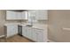 Kitchen area boasts white cabinets, stainless appliances, and light countertops at 5604 Stardust Dr, Durham, NC 27712