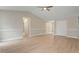 Open-concept living room with high ceilings, hardwood flooring, and view of the hallway and bedrooms at 5604 Stardust Dr, Durham, NC 27712