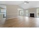 Expansive living room with hardwood floors, a fireplace, ceiling fan, and open concept to kitchen and dining areas at 5604 Stardust Dr, Durham, NC 27712