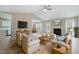 Spacious living room featuring a fireplace, ceiling fan, light hardwood flooring, and comfortable seating at 5604 Stardust Dr, Durham, NC 27712