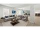 Spacious living room with neutral tones and comfortable seating, leading into a dining area with ample natural light at 570 Freedom Trail Dr, Willow Springs, NC 27592