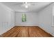 Bedroom showcasing hardwood floors, white walls, a ceiling fan, and a window at 5864 Whitney Rd, Graham, NC 27253