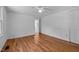 Bedroom with hardwood floors, neutral walls, a ceiling fan and closet space at 5864 Whitney Rd, Graham, NC 27253