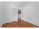 Bedroom with hardwood floors, white walls, and a closet at 5864 Whitney Rd, Graham, NC 27253