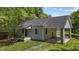 Charming home with a covered porch, side carport, and beautifully landscaped yard at 5864 Whitney Rd, Graham, NC 27253