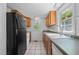 Functional kitchen featuring wood cabinets, modern appliances, and a bright window at 5864 Whitney Rd, Graham, NC 27253