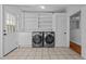 Laundry room with side-by-side washer/dryer, built-in shelves, and exterior access at 5864 Whitney Rd, Graham, NC 27253