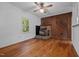 Living room with hardwood floors, a rustic fireplace, and wood paneling at 5864 Whitney Rd, Graham, NC 27253