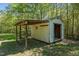 View of the exterior of the outdoor storage shed with an attached cover at 5864 Whitney Rd, Graham, NC 27253