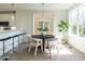 Modern dining area with a round table, stylish chairs, and a view into the kitchen at 620 Walnut Heights Dr # 101, Raleigh, NC 27610