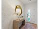 Inviting entryway features stylish wallpaper, decorative mirror, console table with lamp, and front door view at 620 Walnut Heights Dr # 101, Raleigh, NC 27610