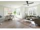 Bright and airy living room with a ceiling fan, large windows, modern furnishings, and vinyl floors at 620 Walnut Heights Dr # 101, Raleigh, NC 27610