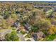 Aerial view of a lush neighborhood featuring well-manicured lawns, mature trees, and beautifully designed homes at 702 Orange Ct, Elon, NC 27244