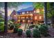 Charming brick home featuring an outdoor swing, stone patio, and a covered porch perfect for entertaining at 702 Orange Ct, Elon, NC 27244