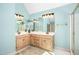 Bright bathroom features a double sink vanity with wood cabinets and large mirror at 702 Orange Ct, Elon, NC 27244