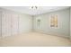 A bedroom with plush carpeting, neutral paint and a pair of large windows at 702 Orange Ct, Elon, NC 27244