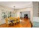Sunny dining room with wood floors and natural light from large windows throughout at 702 Orange Ct, Elon, NC 27244