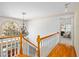 Bright hallway with a staircase featuring hardwood floors and a large arched window at 702 Orange Ct, Elon, NC 27244