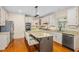 Well-appointed kitchen with granite countertops, stainless steel appliances, and a kitchen island at 702 Orange Ct, Elon, NC 27244