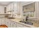 Kitchen area with granite counters, updated appliances, and a bright window overlooking the backyard at 702 Orange Ct, Elon, NC 27244