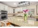 Updated kitchen featuring granite countertops, stainless steel appliances, and a large island at 702 Orange Ct, Elon, NC 27244