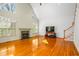 Open living room features wood floors, fireplace, large windows and a staircase at 702 Orange Ct, Elon, NC 27244