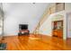 Open living room features wood floors, staircase, and bar at 702 Orange Ct, Elon, NC 27244