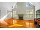 Bright and airy living room with fireplace, large windows, and hardwood floors at 702 Orange Ct, Elon, NC 27244