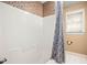 Bathroom shower with decorative tile and shower curtain at 702 Orange Ct, Elon, NC 27244