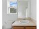 Bathroom featuring a classic vanity, a toilet, and a window with natural light at 707 Obsidian Way, Durham, NC 27703