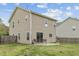 Back of house with lawn, small patio, and the house with many windows at 707 Obsidian Way, Durham, NC 27703