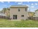 View of the back of the house showing a patio and a large green lawn at 707 Obsidian Way, Durham, NC 27703