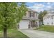 Charming two-story home with an attached single-car garage and a well-kept lawn at 707 Obsidian Way, Durham, NC 27703