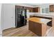 Kitchen features wooden cabinets, modern appliances, and a convenient kitchen island at 707 Obsidian Way, Durham, NC 27703