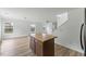 Open-concept living area with wood-look floors and a kitchen island, perfect for entertaining at 707 Obsidian Way, Durham, NC 27703