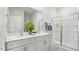 Modern bathroom featuring a double sink vanity and a glass-enclosed shower at 712 Holstein Dairy Way, Wake Forest, NC 27587