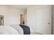 Neutral bedroom featuring a bed with grey throw and view to the ensuite bathroom at 712 Holstein Dairy Way, Wake Forest, NC 27587