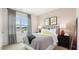 Cozy bedroom with a double bed, a window view, and matching bedside tables with lamps at 712 Holstein Dairy Way, Wake Forest, NC 27587