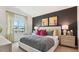Stylish bedroom featuring a large bed, two side tables and a window overlooking neighborhood construction at 712 Holstein Dairy Way, Wake Forest, NC 27587