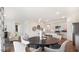 Elegant dining area open to the kitchen, featuring a round table and modern decor for seamless entertaining at 712 Holstein Dairy Way, Wake Forest, NC 27587